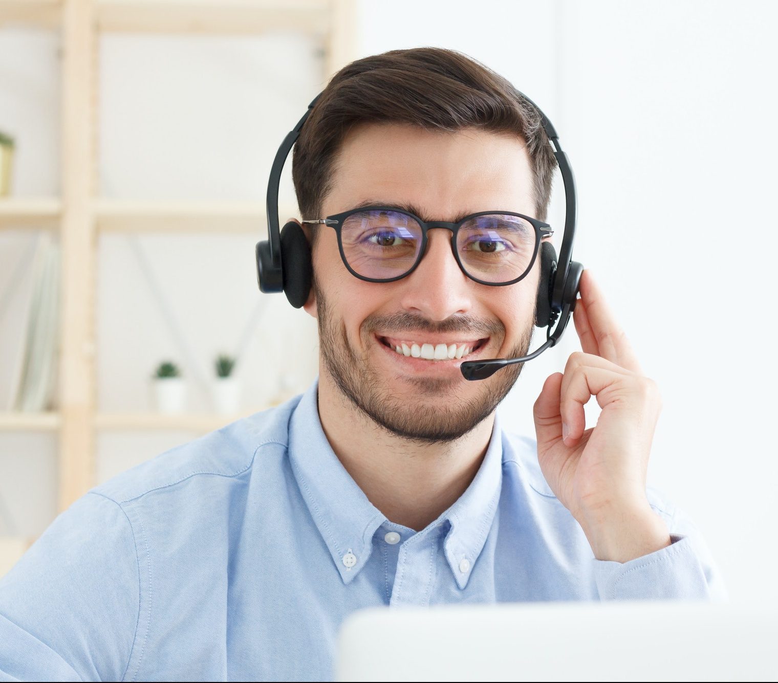 Portrait of young male technical support in call centre